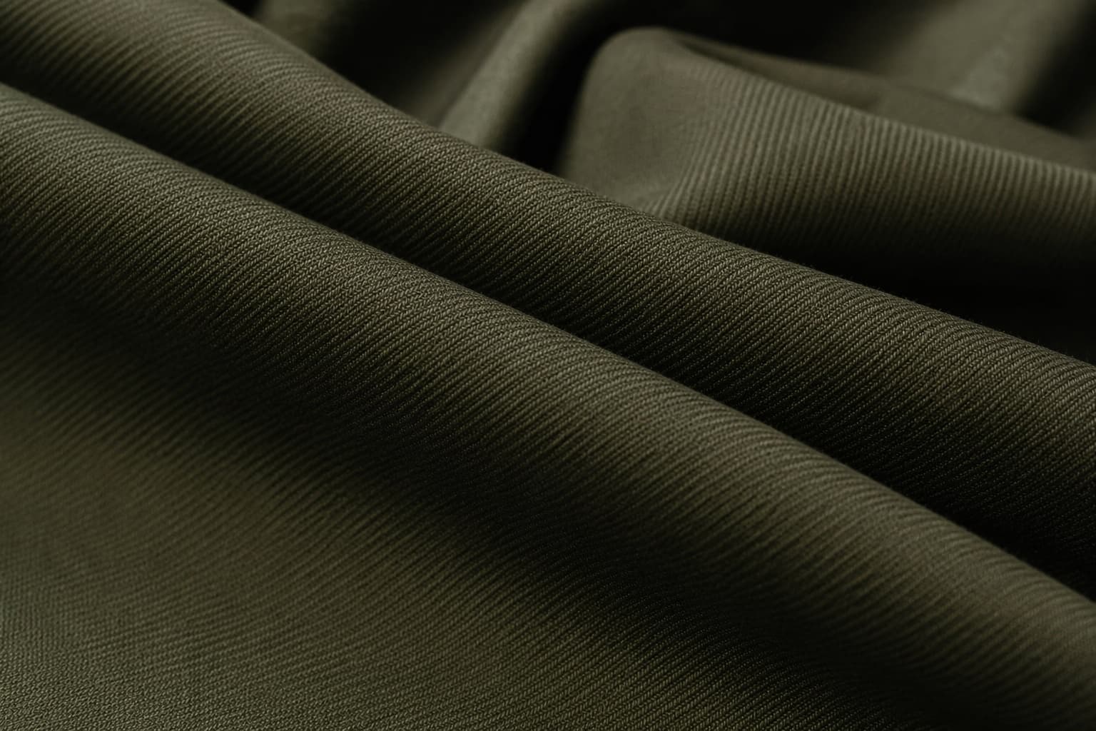 Close-up of olive-green military twill fabric showing structured weave for army uniform manufacturing