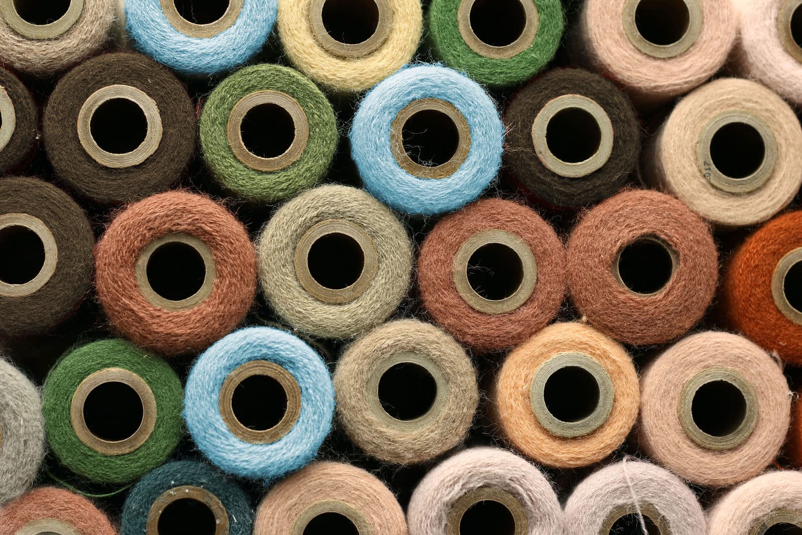 Cones of coloured yarn