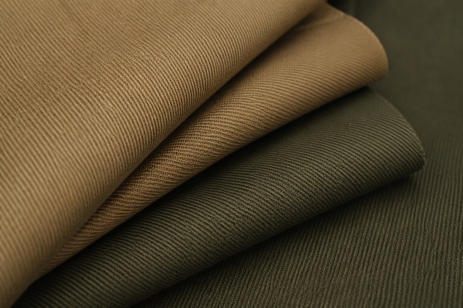 Heavy twill workwear fabric in utility khaki and olive shades suited to construction site wear